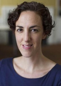An image of Hannah Freed-Thall's face in a purple shirt.