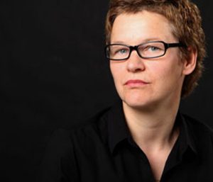 A woman looks at the camera.